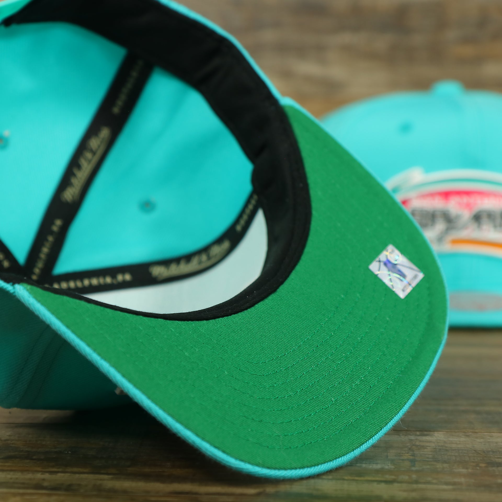 Green under visor of the San Antonio Spurs Vintage Retro NBA Team Ground 2.0 Mitchell and Ness Snapback Hat | Teal