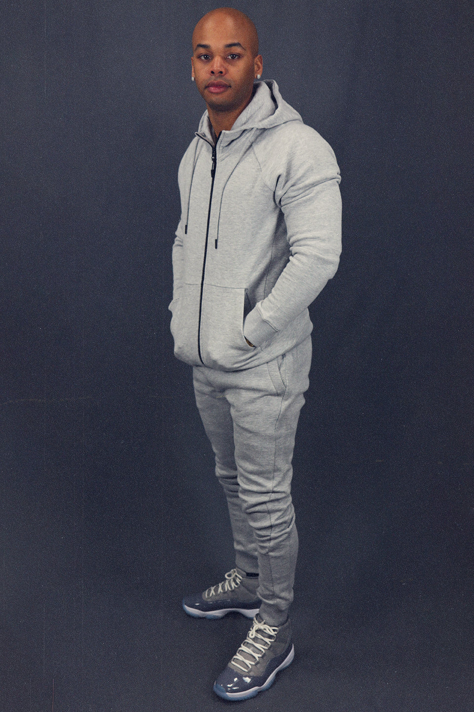 full view of the matching set of the Men's Heather Grey Fleece Sweatpants Jogger Pants Bottom To Match Sneakers