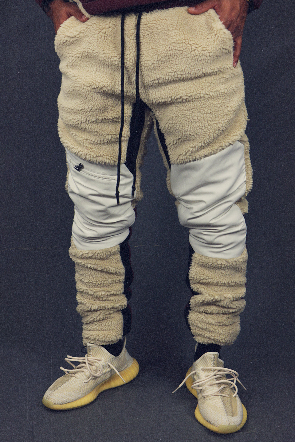 front of the Foliage Sherpa Tech Pants With Zipper Pockets For Sherpa Two Piece Set To Match Sneakers