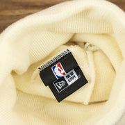 The New Era Tag on the Philadelphia 76ers NBA City Series Cracker Liberty Bell Winter Beanie | Cream Winter Beanie
