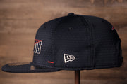 The wearers left side has the new era logo on it Patriots 2020 Training Camp Snapback Hat | New England Patriots 2020 On-Field Navy Training Camp Snap Cap