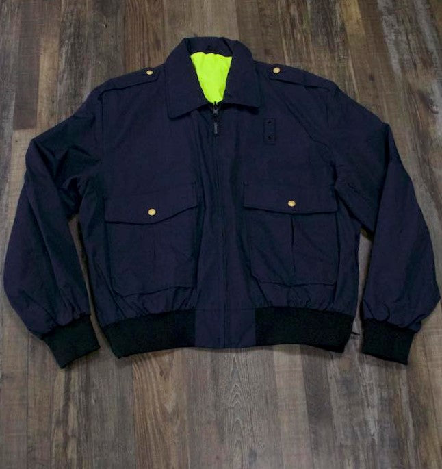 on the front of the Police Public Safety | Reversible Navy Blue Uniform Bomber Jacket | Waterproof Scotchlite Reflective Safety Green and Blue Rain Jacket is patch pockets and gold buttons