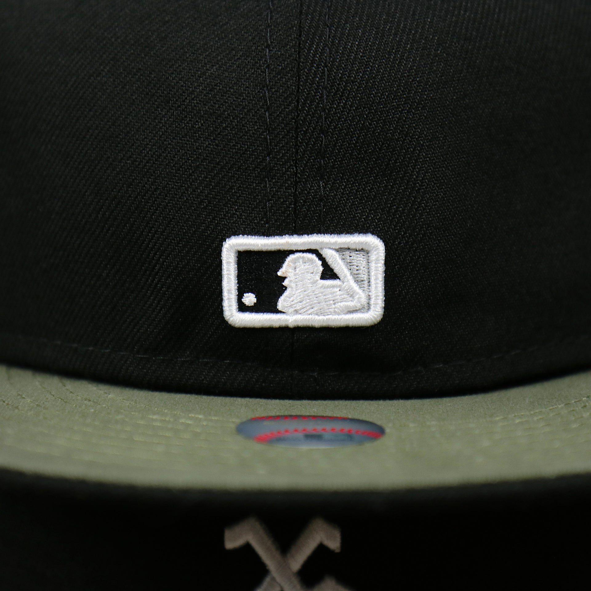 The MLB Batterman Logo on the Chicago White Sox Alpha Industries Side Patch Army Green Undervisor 59FIfty Fitted Cap With Hangtag | Black 59FIfty Cap