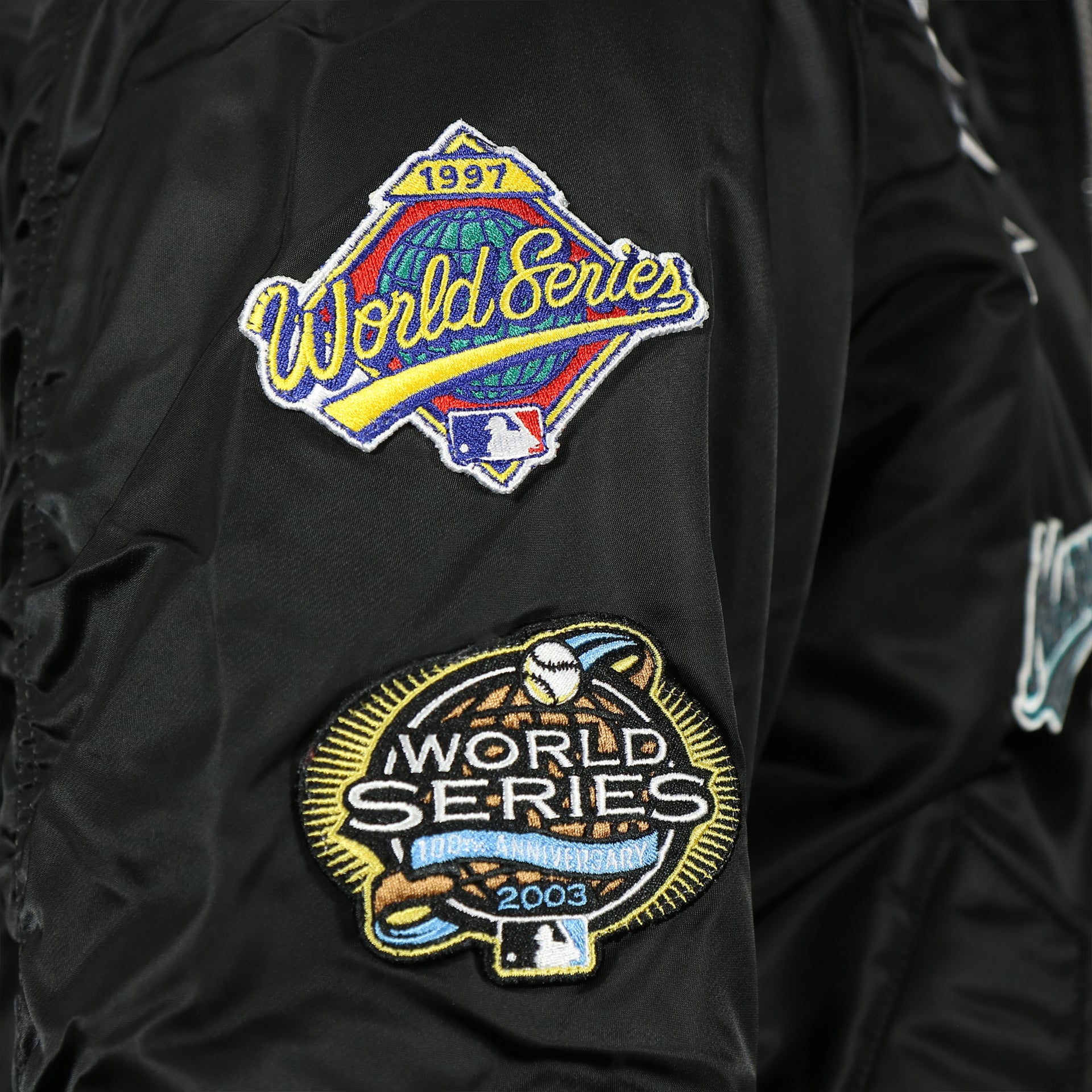 1997 and 2003 world series patches on the Florida Marlins MLB Patch Alpha Industries Reversible Bomber Jacket With Camo Liner | Black Bomber Jacket