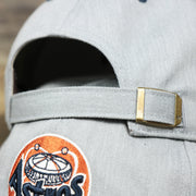 The adjustable strap on the Cooperstown Houston Astros 1980s Logo Green Bottom Dad Hat | Gray Dad Hat