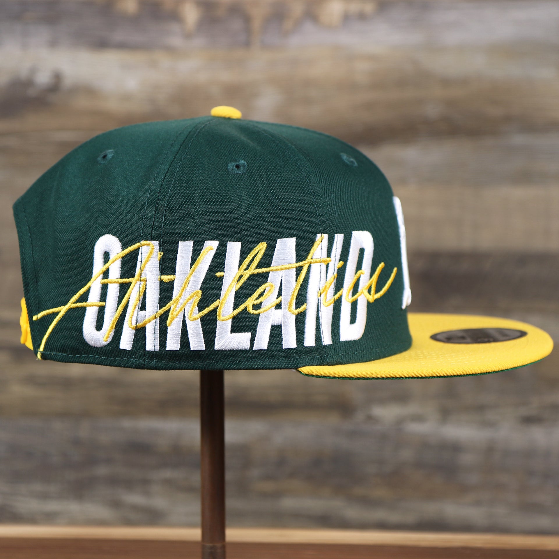 The wearer's right on the Oakland Athletics MLB Side Font Green Bottom 9Fifty Snapback Cap | Black Snap Cap