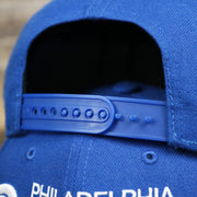 The royal blue adjustable strap on the Cooperstown Philadelphia Athletics Wordmark Retro Athletics Side Patch Snapback | Royal Blue Snapback