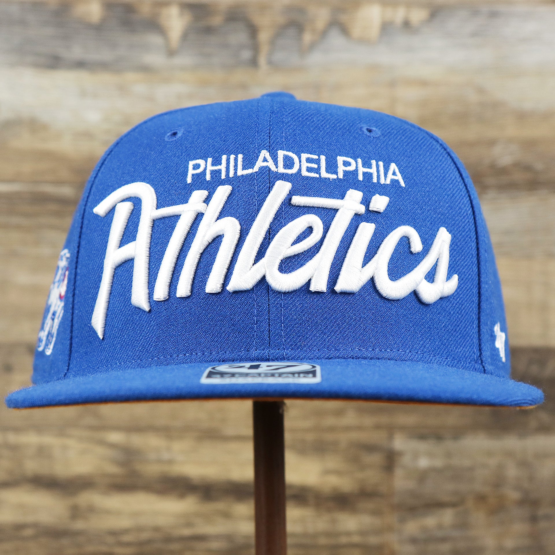 The front of the Cooperstown Philadelphia Athletics Wordmark Retro Athletics Side Patch Snapback | Royal Blue Snapback
