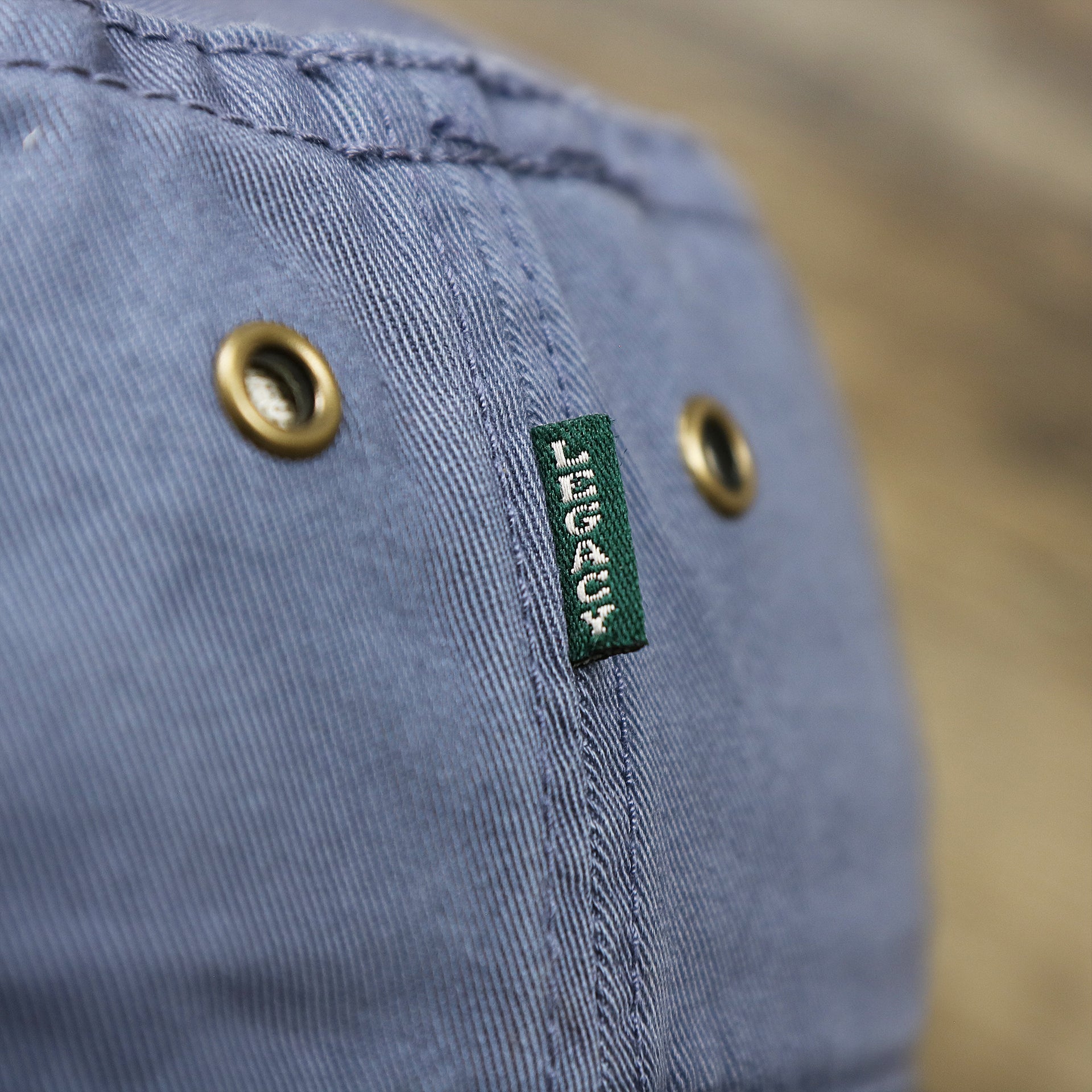 The Green Legacy Tag on the Ocean City Anchor New Jersey Wordmark Bucket Hat | Slate Blue Bucket Hat