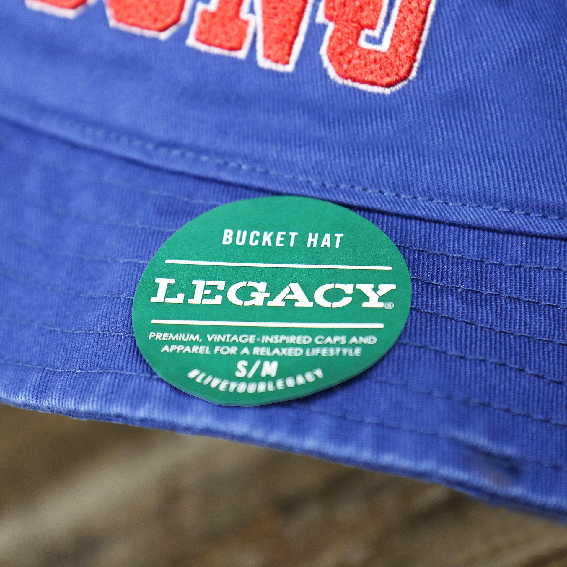 The Legacy Sticker on the Ocean City New Jersey OCNJ Wordmark Bucket Hat | Royal Blue Bucket Hat