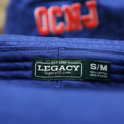 The Legacy Tag on the Ocean City New Jersey OCNJ Wordmark Bucket Hat | Royal Blue Bucket Hat