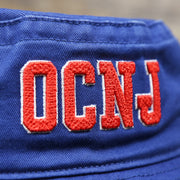 The OCNJ Wordmark on the Ocean City New Jersey OCNJ Wordmark Bucket Hat | Royal Blue Bucket Hat
