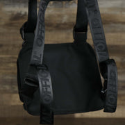 The backside of the Streetwear Tactics Chest Bag Utility Vest | Official Black while hanging