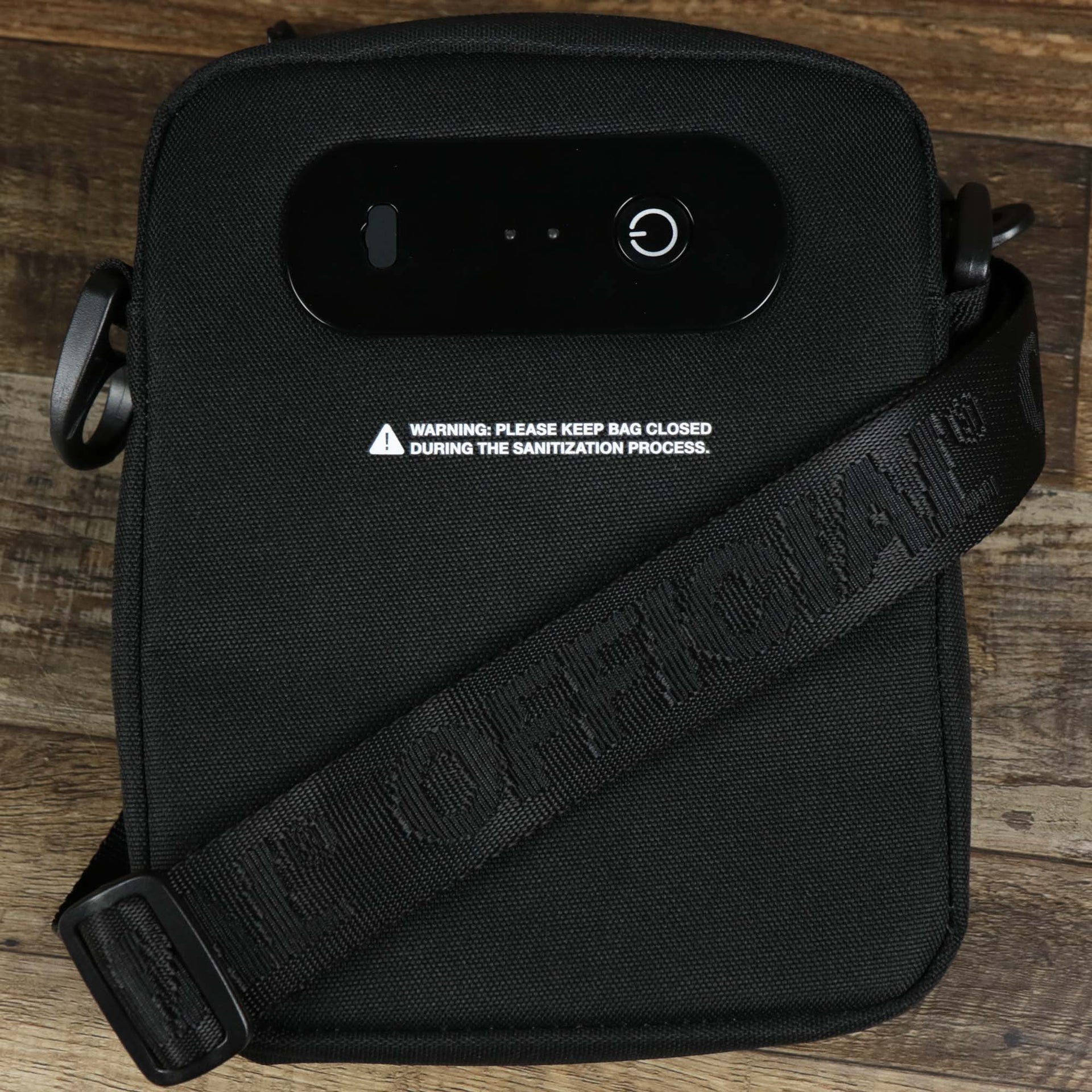 The backsides of the UVC Sterilization Shoulder Bag Streetwear | Official Black with the official strap