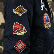 The Braves World Series Side Patches on the Atlanta Braves MLB Patch Alpha Industries Reversible Bomber Jacket With Camo Liner | Navy Blue Bomber Jacket