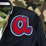 The Lower Case a Logo side Patch on the Atlanta Braves MLB Patch Alpha Industries Reversible Bomber Jacket With Camo Liner | Navy Blue Bomber Jacket