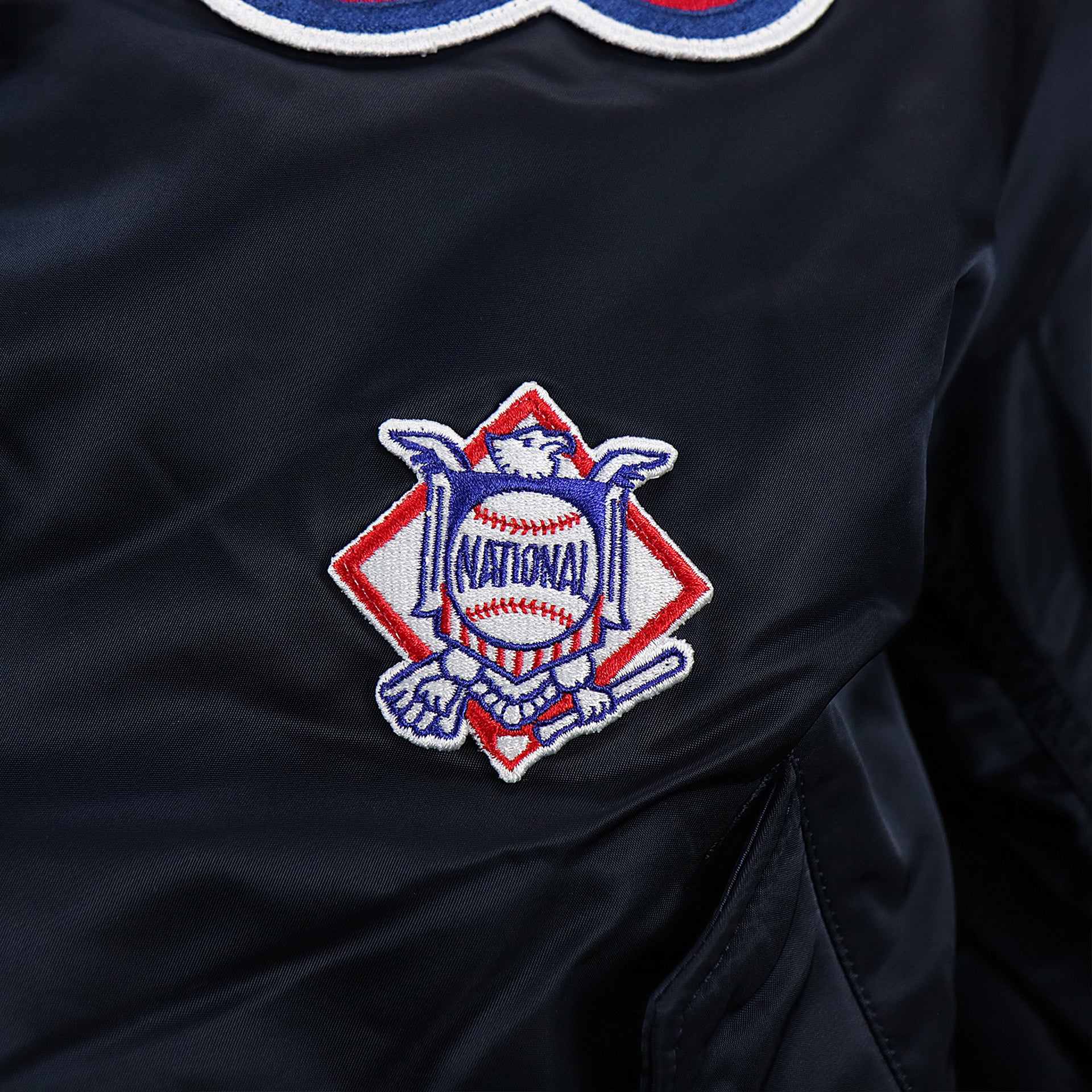 The National Baseball league on the Atlanta Braves MLB Patch Alpha Industries Reversible Bomber Jacket With Camo Liner | Navy Blue Bomber Jacket
