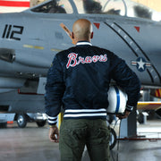The backside of the Atlanta Braves MLB Patch Alpha Industries Reversible Bomber Jacket With Camo Liner | Navy Blue Bomber Jacket with a matching helmet