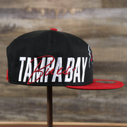 The wearer's right on the Tampa Bay Buccaneers NFL Side Font Green Bottom 9Fifty Snapback Cap | Black Snap Cap