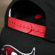 The Red Adjustable Strap on the Tampa Bay Buccaneers NFL Side Font Green Bottom 9Fifty Snapback Cap | Black Snap Cap