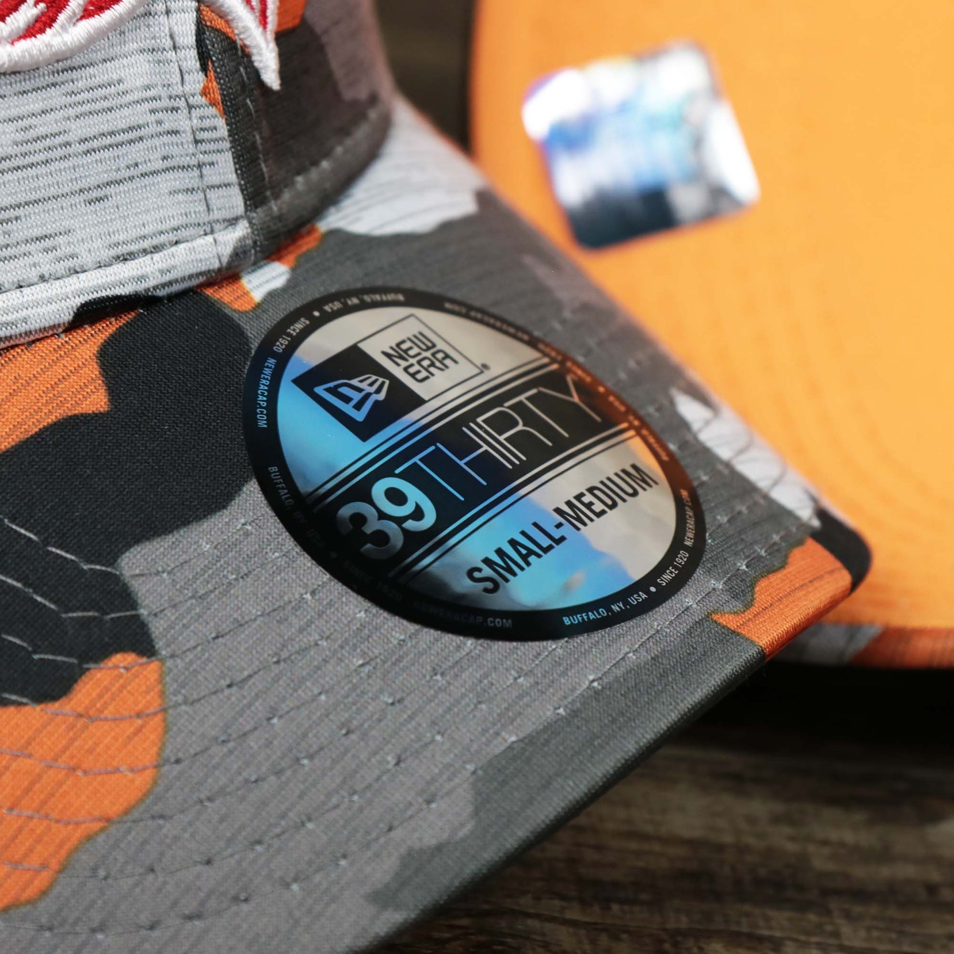 The 39Thirty Sticker on the Throwback Tampa Bay Buccaneers OnField NFL Summer Training 2022 39Thirty Camo FlexFit Cap | New Era Orange