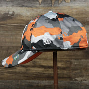 The wearer's right of the Throwback Tampa Bay Buccaneers OnField NFL Summer Training 2022 39Thirty Camo FlexFit Cap | New Era Orange