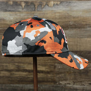 The wearer's right on the Throwback Tampa Bay Buccaneers OnField NFL Summer Training 2022 39Thirty Camo FlexFit Cap | New Era Orange