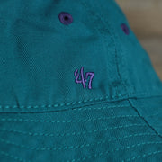 A close up of the 47 Brand logo on the Mighty Ducks Vintage 90s Anaheim Ducks Grape 5s Matching Bucket Hat | 47 Brand, Dark Teal