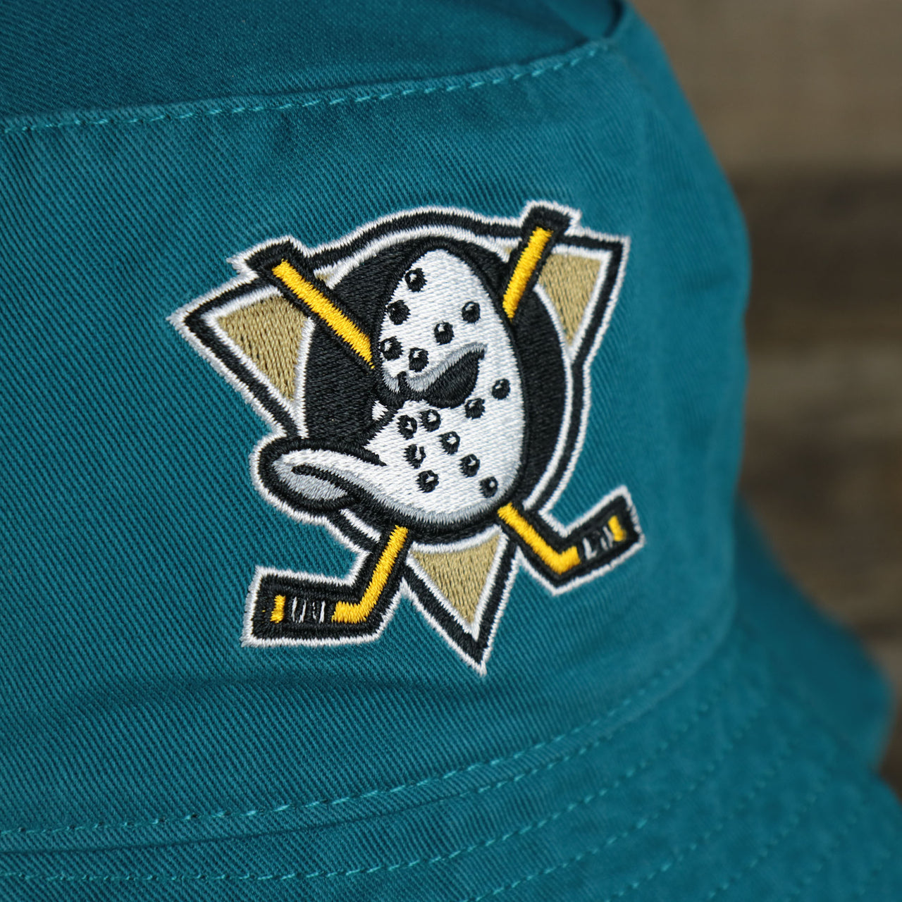 A close up of the Mighty Ducks logo on the Mighty Ducks Vintage 90s Anaheim Ducks Grape 5s Matching Bucket Hat | 47 Brand, Dark Teal