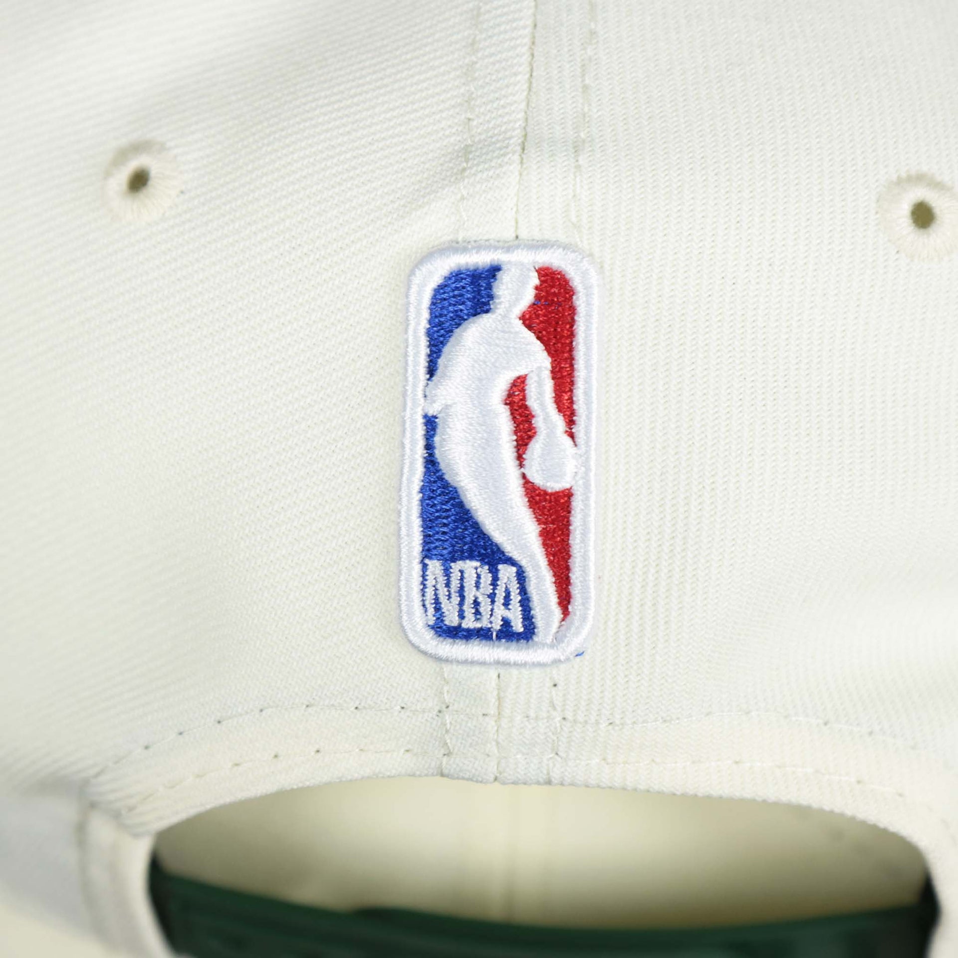 The NBA Jerry West Logo on the back of the Youth Milwaukee Bucks NBA 2022 Draft Gray Bottom 9Fifty Snapback | New Era Cream/Green