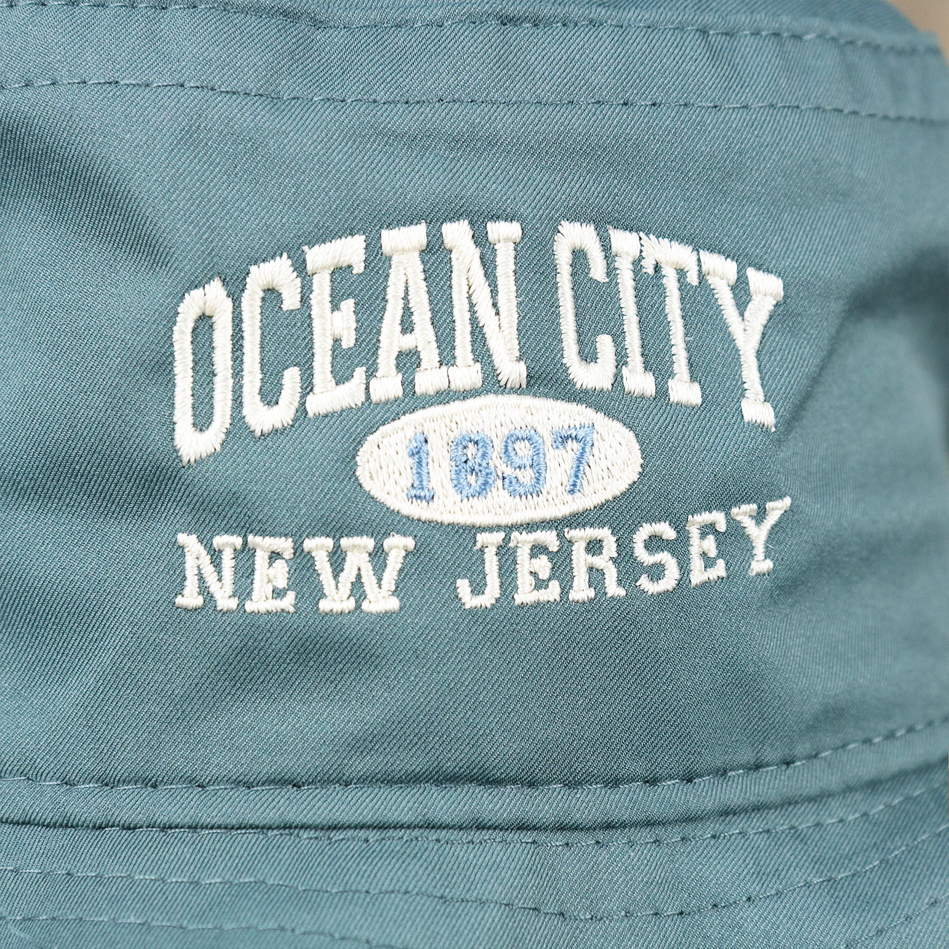 The Ocean City New Jersey Wordmark on the Ocean City New Jersey 1897 Bucket Hat | Blue Steel Bucket Hat