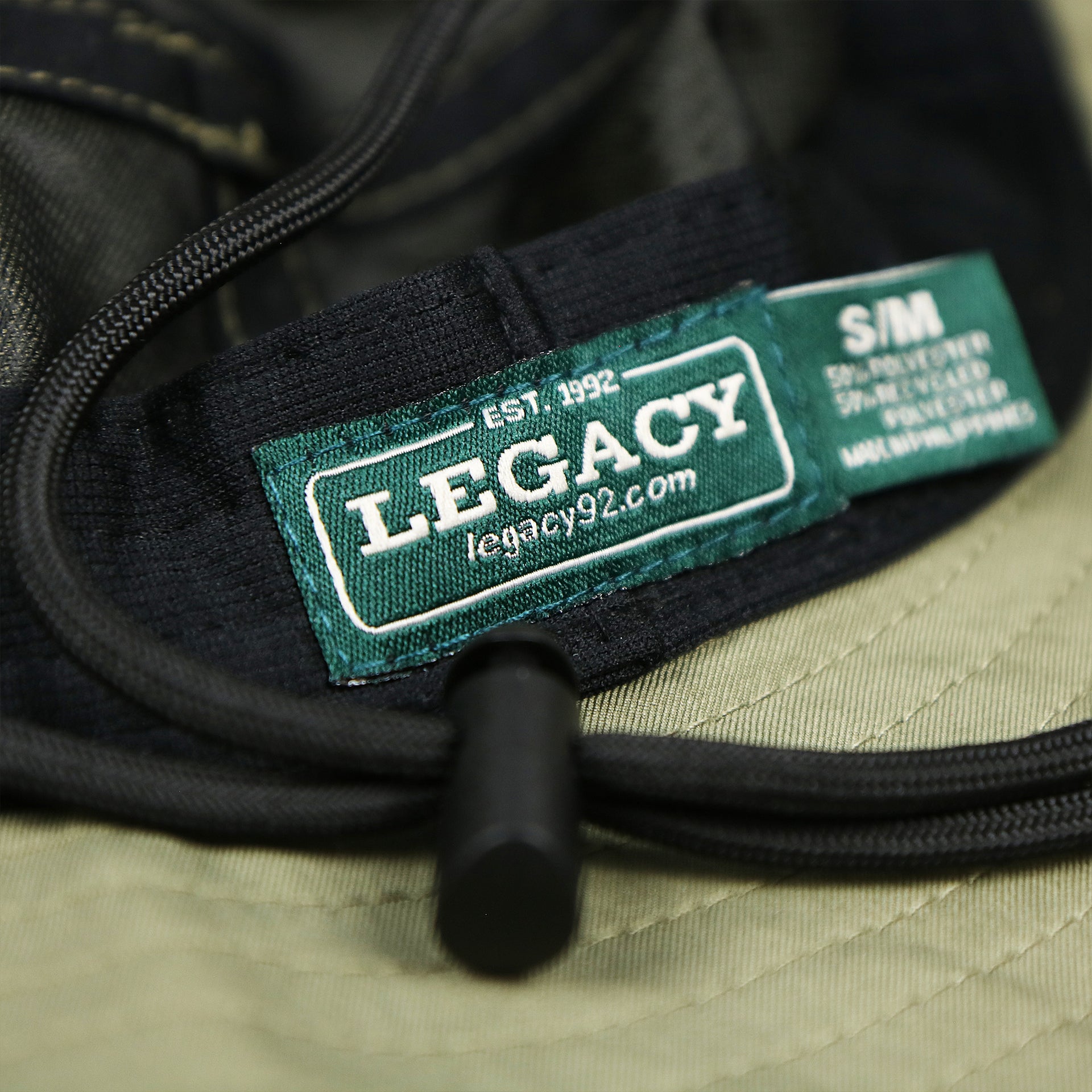 The Legacy tag on the Ocean City New Jersey Wordmark Since 1897 Bucket Hat | Moss Green Bucket Hat