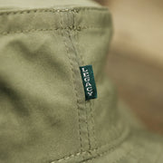 The Green Legacy Tag on the Ocean City New Jersey Wordmark Since 1897 Bucket Hat | Moss Green Bucket Hat