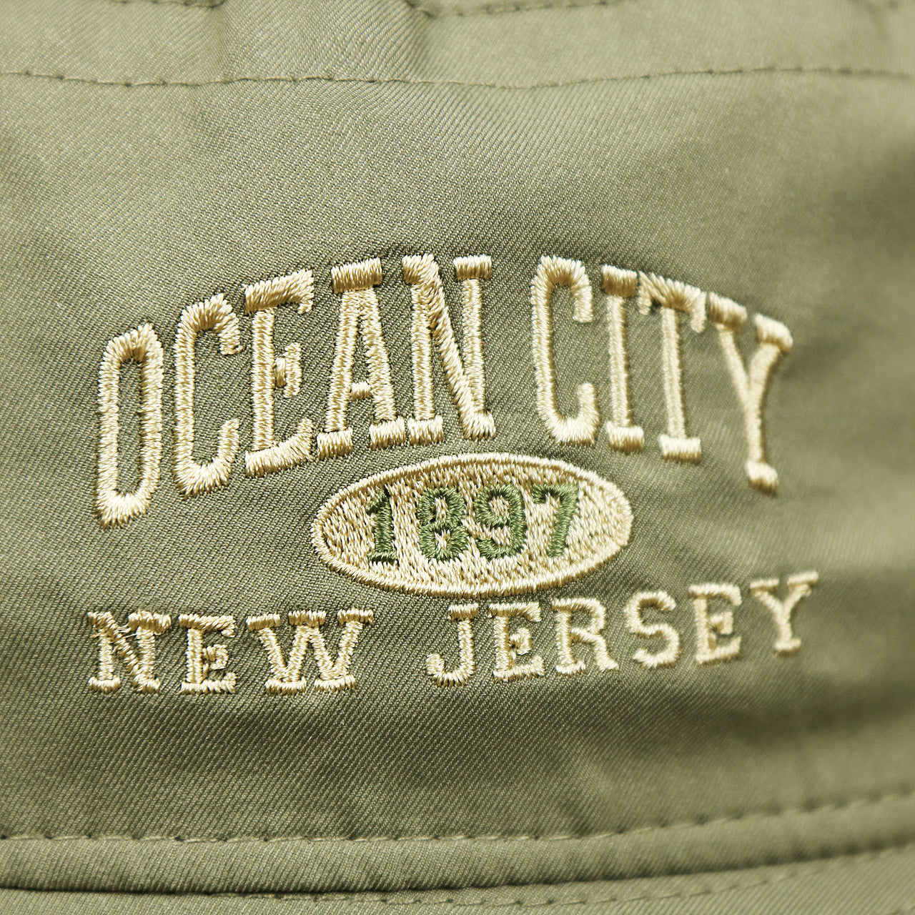 The embroidery on the Ocean City New Jersey Wordmark Since 1897 Bucket Hat | Moss Green Bucket Hat