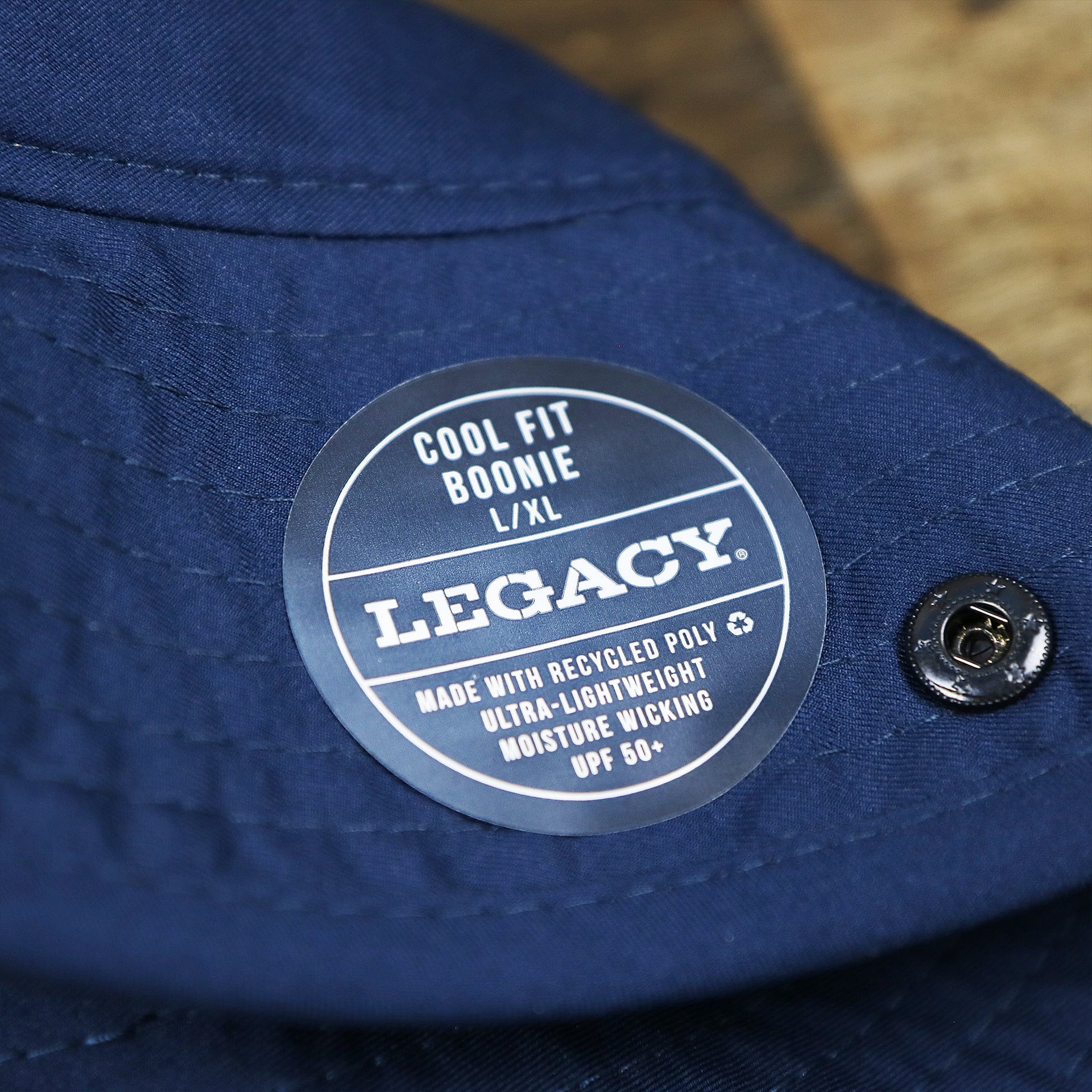 The Legacy Tag on the Ocean City Wordmark Parallel Oars New Jersey Bucket Hat | Navy Blue Bucket Hat