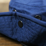 The sides pinned on the Ocean City Wordmark Parallel Oars New Jersey Bucket Hat | Navy Blue Bucket Hat
