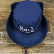The Ocean City Wordmark Parallel Oars New Jersey Bucket Hat | Navy Blue Bucket Hat with the sides pinned 