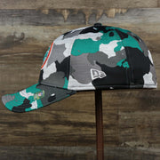 The wearer's left on the Throwback Miami Dolphins OnField NFL Summer Training 2022 39Thirty Camo FlexFit Cap | New Era Turquoise