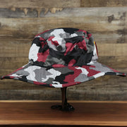 The wearer's right on the Washington Commanders NFL Summer Training Camp 2022 Camo Bucket Hat | Burgundy Bucket Hat