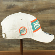 The wearer's right on the Throwback Miami Dolphins Striped Wordmark Legacy Dolphins Side Patch Crossroad Dad Hat | Bone Dad Hat