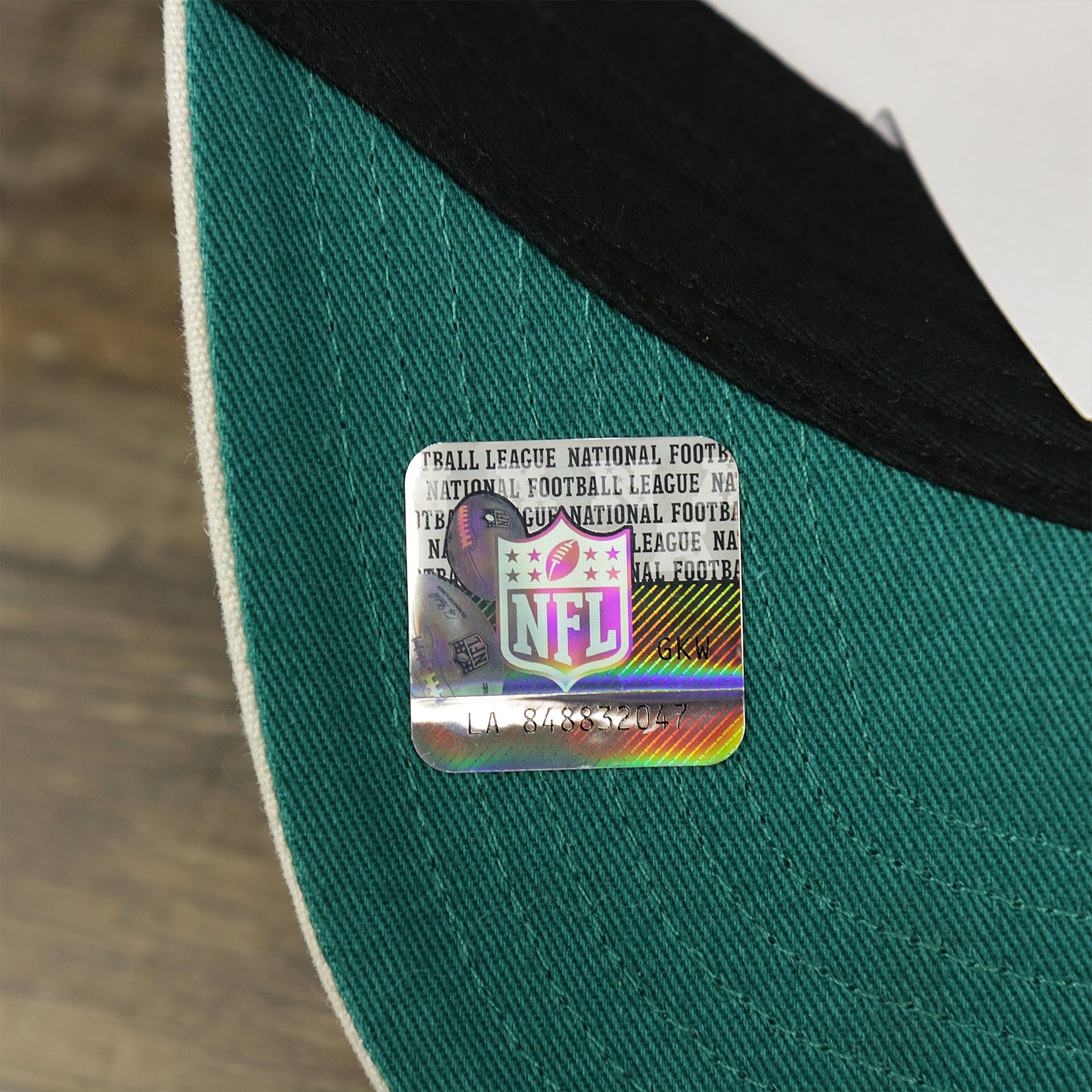 The NFL Sticker on the Throwback Miami Dolphins Striped Wordmark Legacy Dolphins Side Patch Crossroad Dad Hat | Bone Dad Hat
