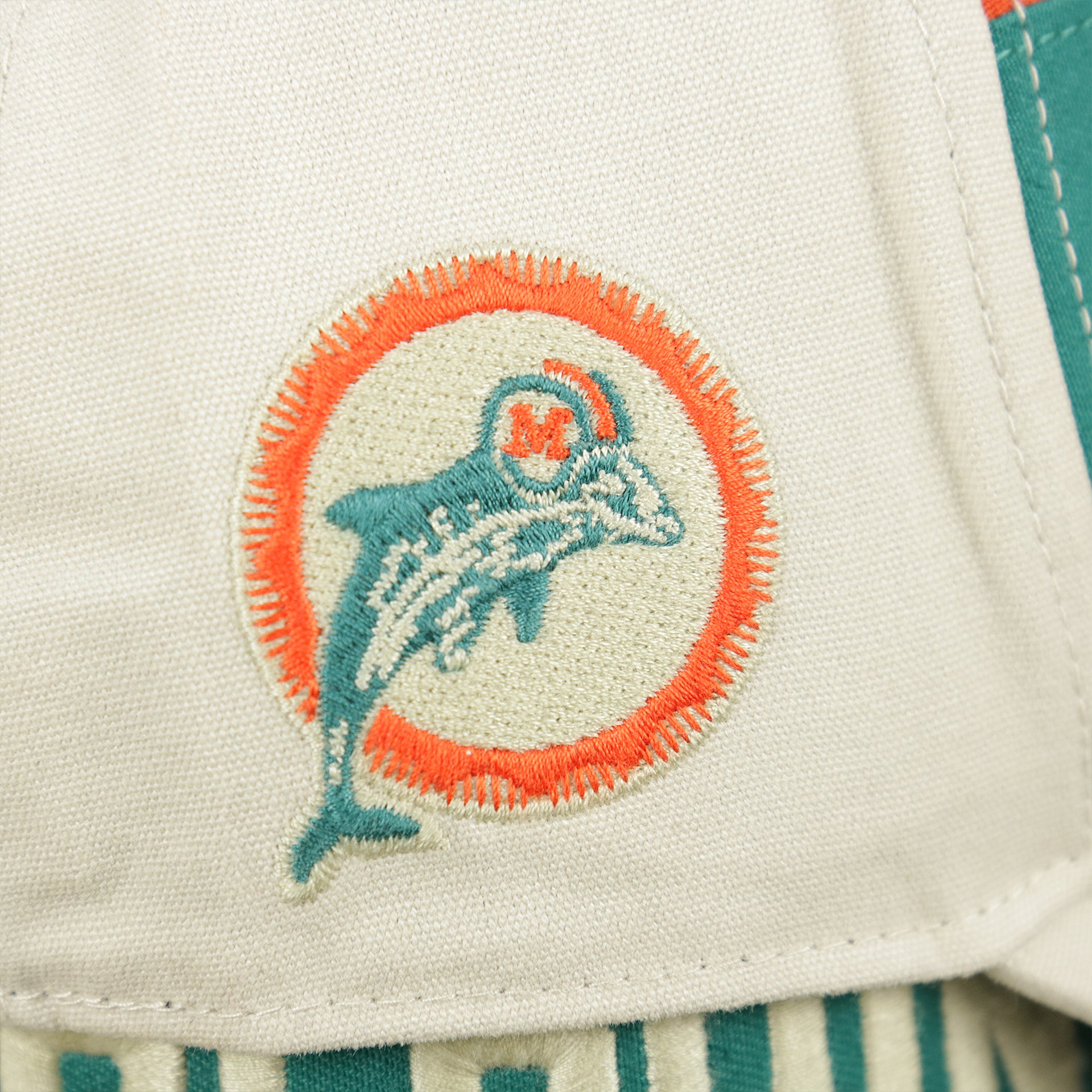The Vintage Dolphins Patch on the Throwback Miami Dolphins Striped Wordmark Legacy Dolphins Side Patch Crossroad Dad Hat | Bone Dad Hat