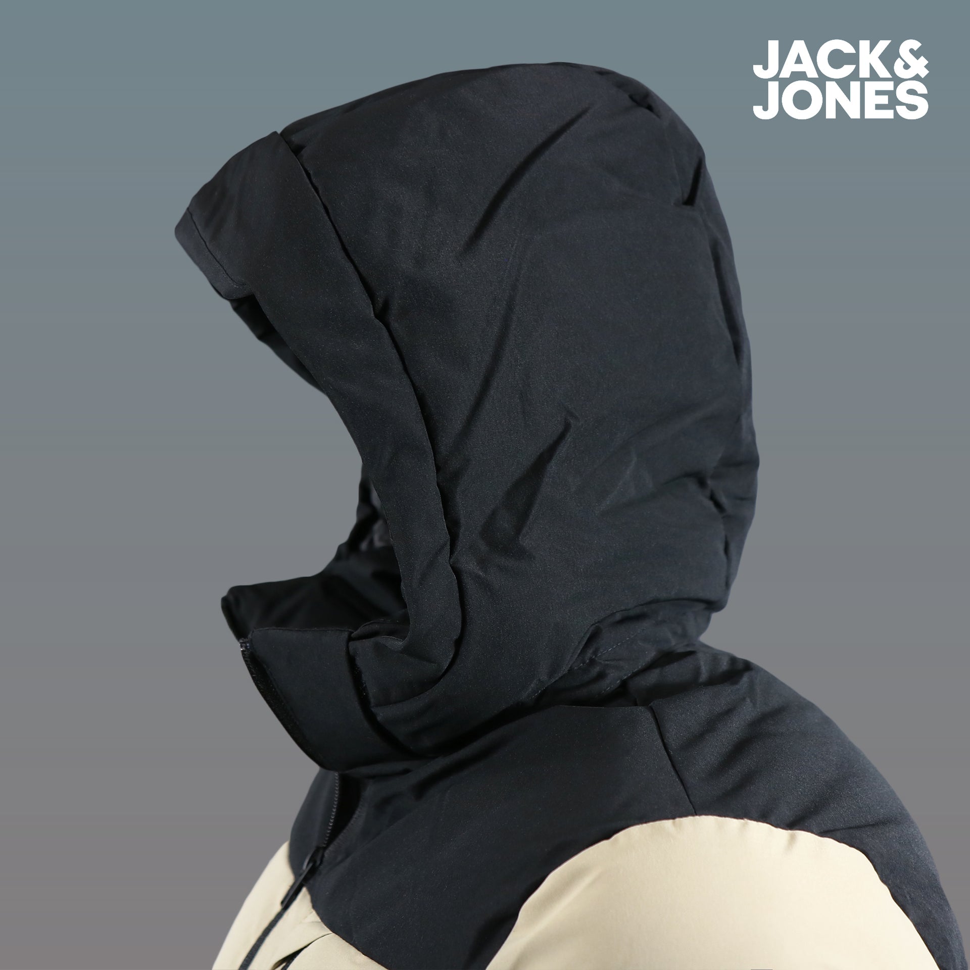 The hood on the Jack And Jones Dune Puffer Jacket With Hidden Pocket | Black and Tan Puffer Jacket
