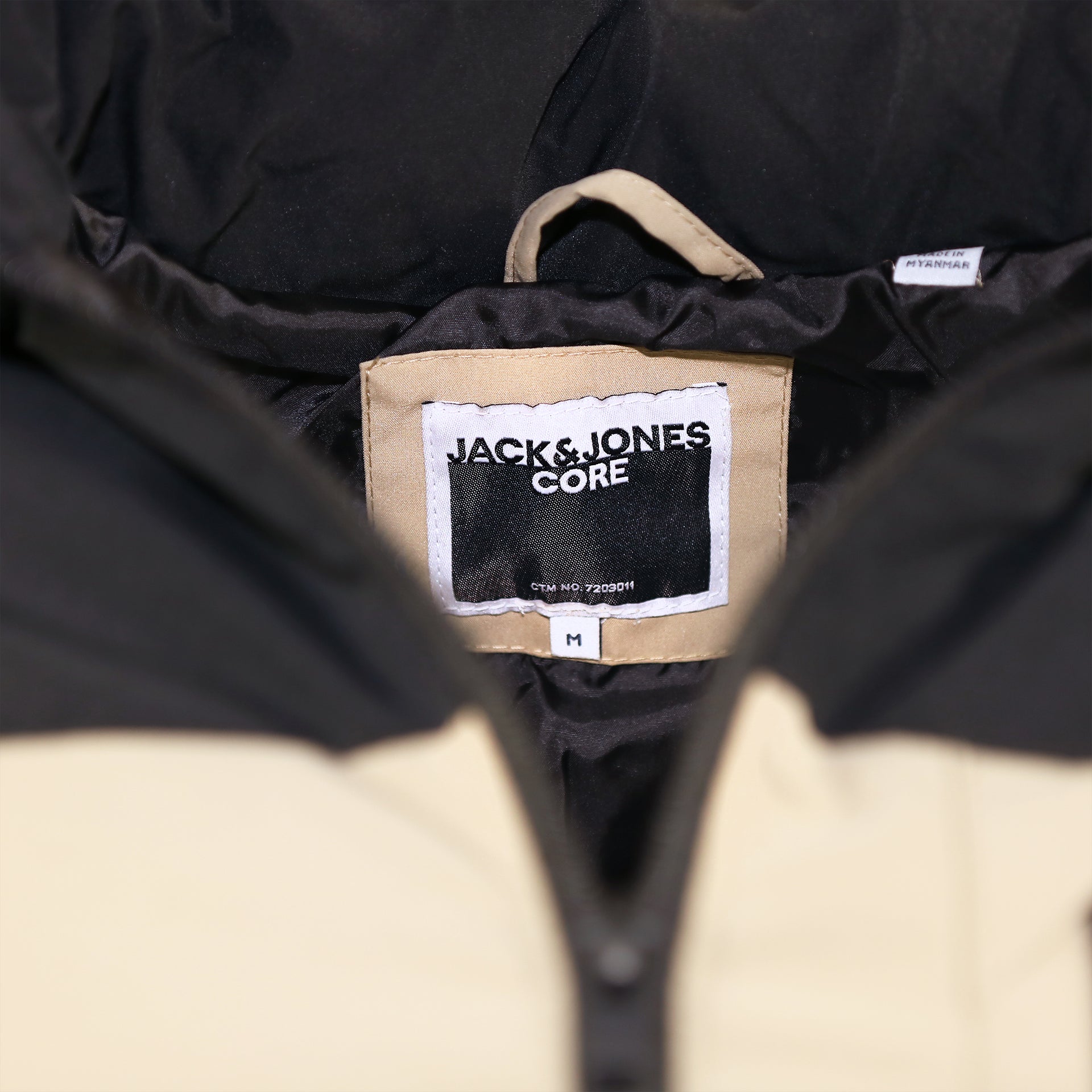 The Jack & Jones Tag on the Jack And Jones Dune Puffer Jacket With Hidden Pocket | Black and Tan Puffer Jacket