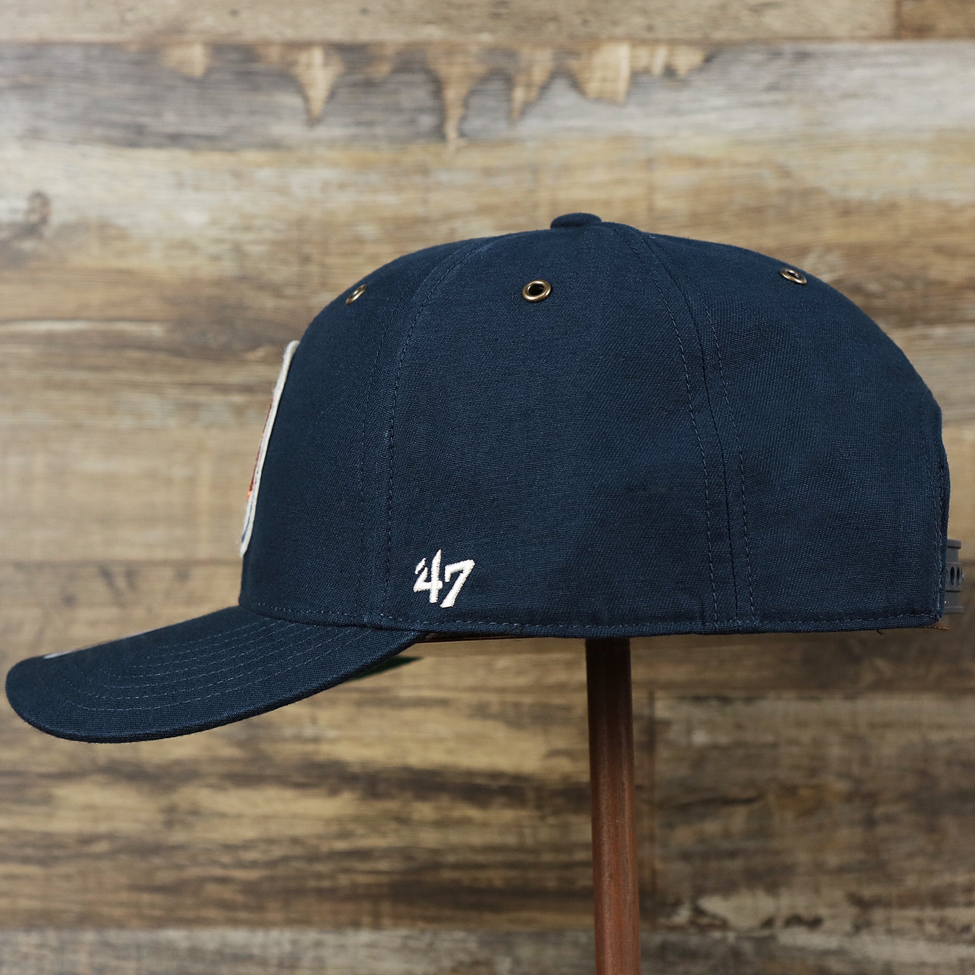 The wearer's left on the Cooperstown Detroit Tigers Felt Tigers Logo Snapback Hat | Navy Blue Snapback Cap
