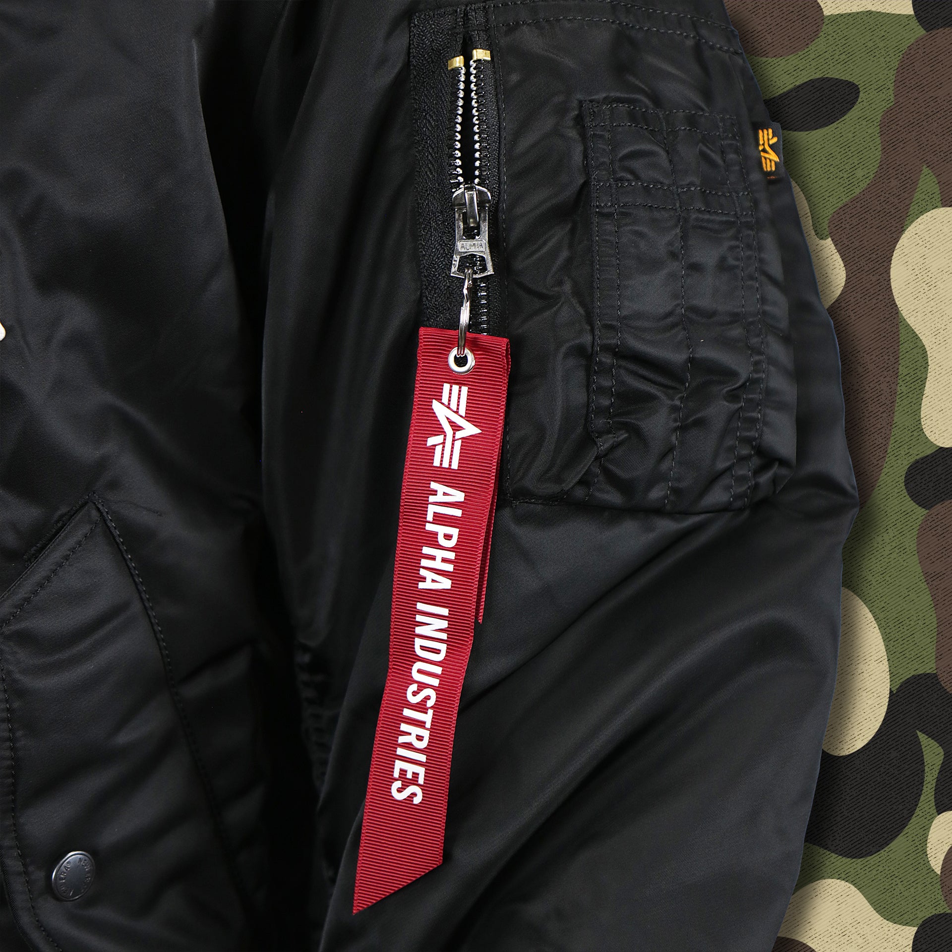 The Alpha Industries Hangtag on the Cooperstown Arizona Diamondbacks MLB Patch Alpha Industries Reversible Bomber Jacket With Camo Liner | Black Bomber Jacket
