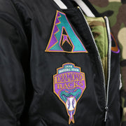 The Cooperstown Diamondback Logo Side Patch and the 1998 Inaugural Season Diamondbacks Side Patch on the Cooperstown Arizona Diamondbacks MLB Patch Alpha Industries Reversible Bomber Jacket With Camo Liner | Black Bomber Jacket