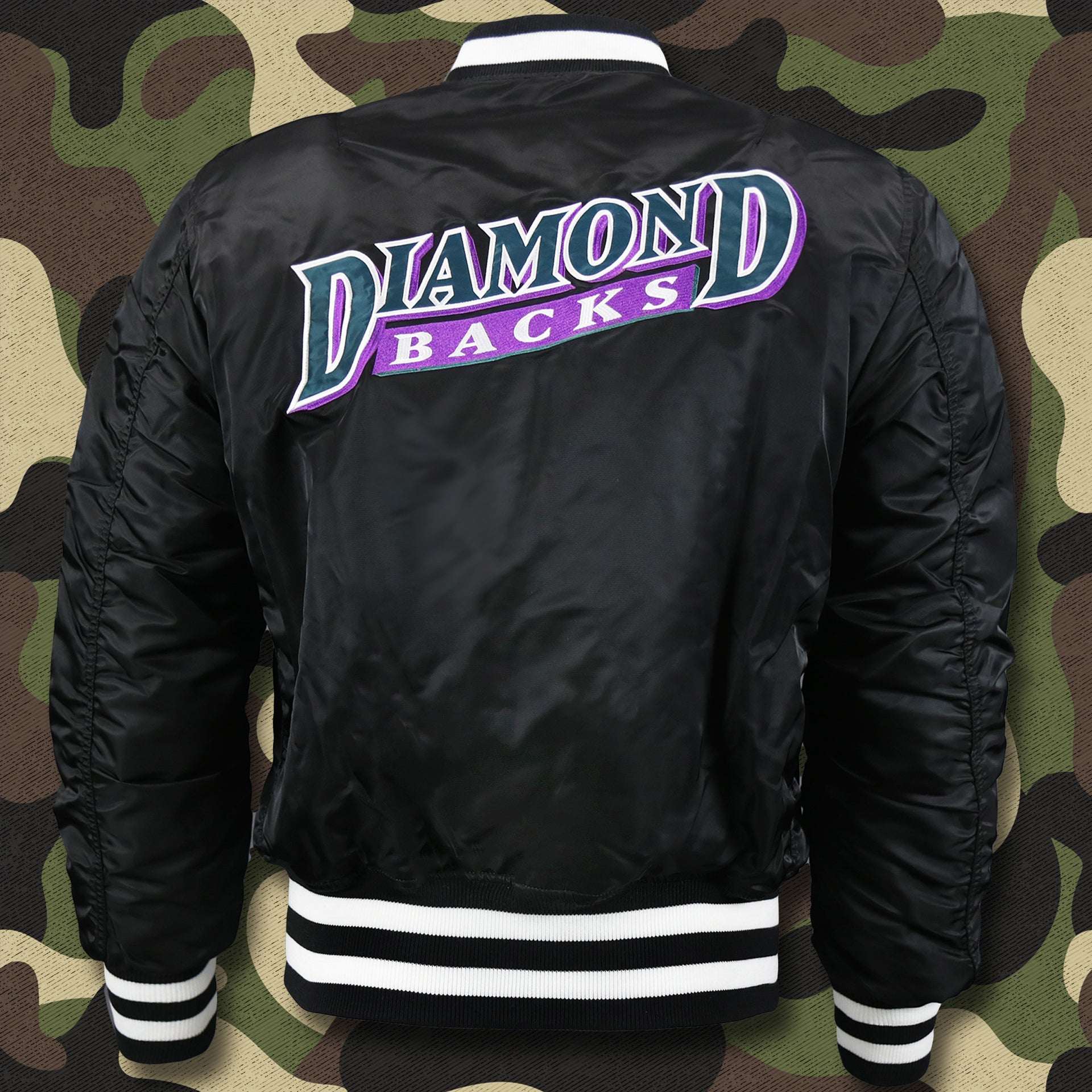 The backside of the Cooperstown Arizona Diamondbacks MLB Patch Alpha Industries Reversible Bomber Jacket With Camo Liner | Black Bomber Jacket