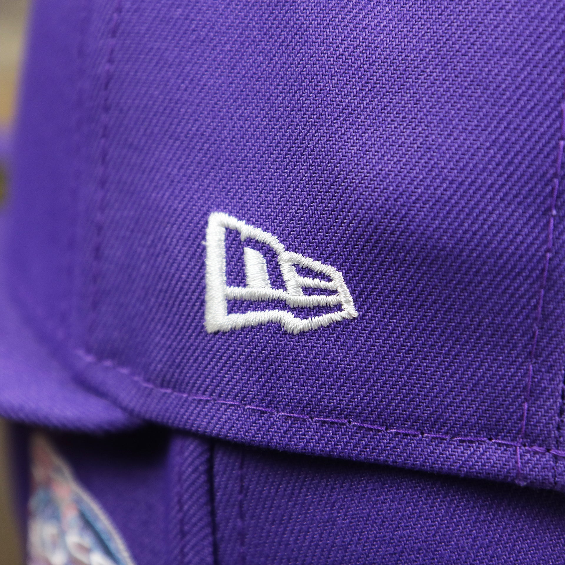 The New Era Logo on the Cooperstown Arizona Diamondbacks Pop Sweat Pastel World Series Side Patch Fitted Cap With Pink Undervisor | Purple 59Fifty Cap