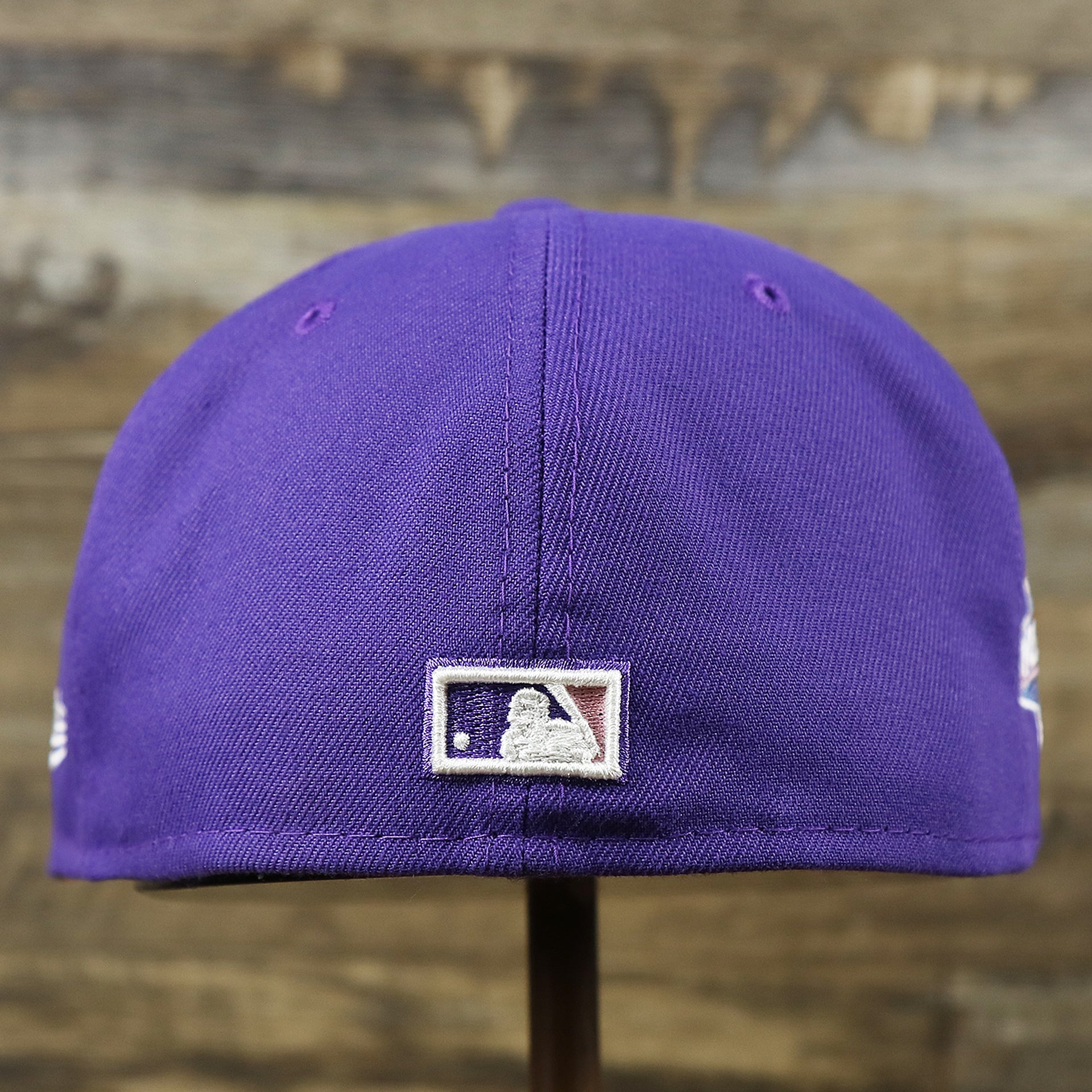 The backside of the Cooperstown Arizona Diamondbacks Pop Sweat Pastel World Series Side Patch Fitted Cap With Pink Undervisor | Purple 59Fifty Cap